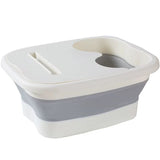 Bassine bain de pied pliante avec compartiment et bouchon/poche pour pédicure, couleur gris blanc.